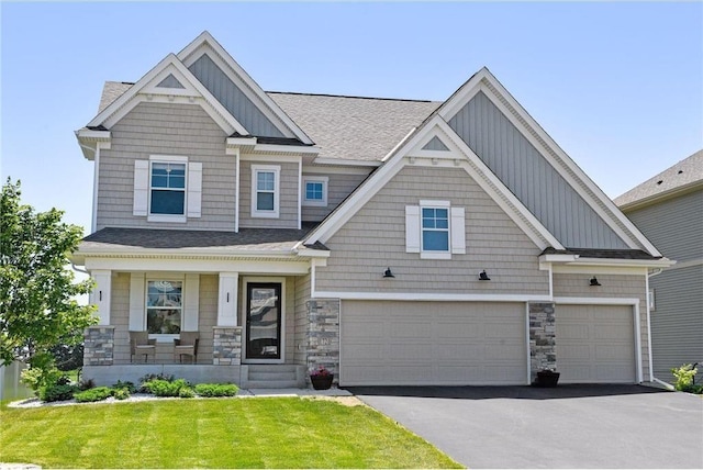 1721 Pebblestone Rd, Carver, MN 55315 - craftsman inspired home with asphalt driveway, a garage, board and batten siding, stone siding, and a porch