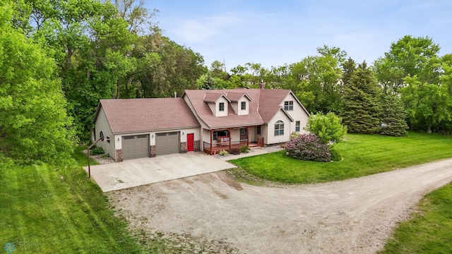 20482 28th Ave N, Cromwell Twp, MN 56549 - new england style home featuring covered porch, concrete driveway, an attached garage, and a front lawn