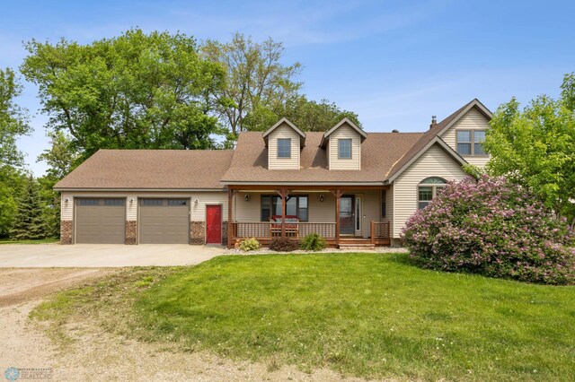 20482 28th Ave N, Cromwell Twp, MN 56549 - view of front of house featuring covered porch, an attached garage, driveway, a front yard, and roof with shingles