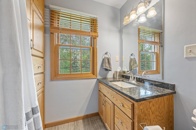 20482 28th Ave N, Cromwell Twp, MN 56549 - bathroom with vanity, baseboards, and wood finished floors