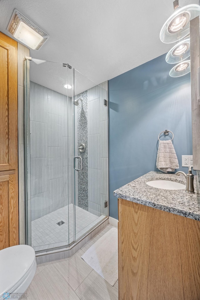 20482 28th Ave N, Cromwell Twp, MN 56549 - bathroom featuring a shower stall, toilet, vanity, and tile patterned flooring