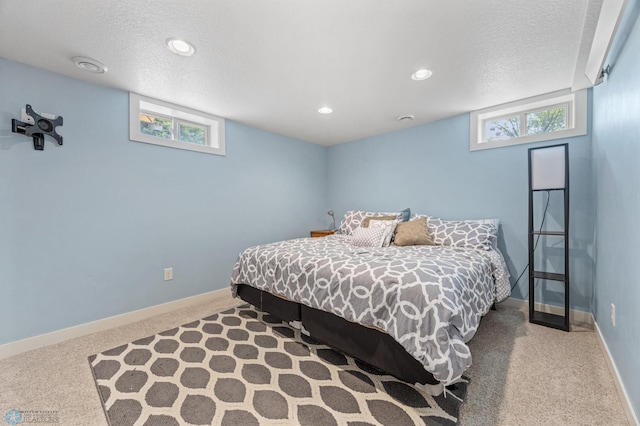 20482 28th Ave N, Cromwell Twp, MN 56549 - carpeted bedroom featuring multiple windows, baseboards, a textured ceiling, and recessed lighting
