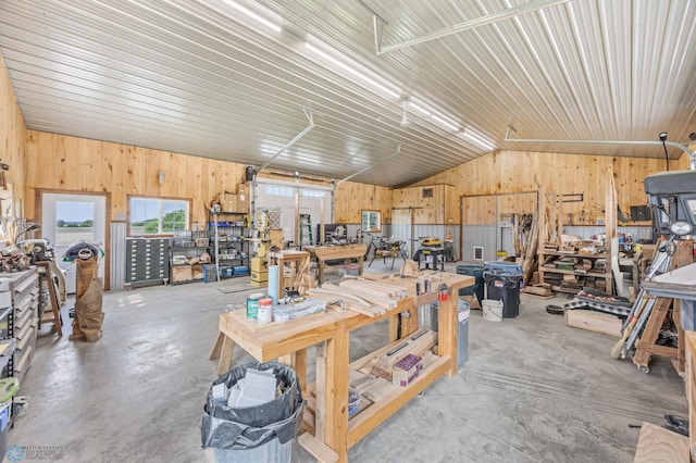 20482 28th Ave N, Cromwell Twp, MN 56549 - miscellaneous room with a workshop area, wood walls, lofted ceiling, concrete flooring, and a garage