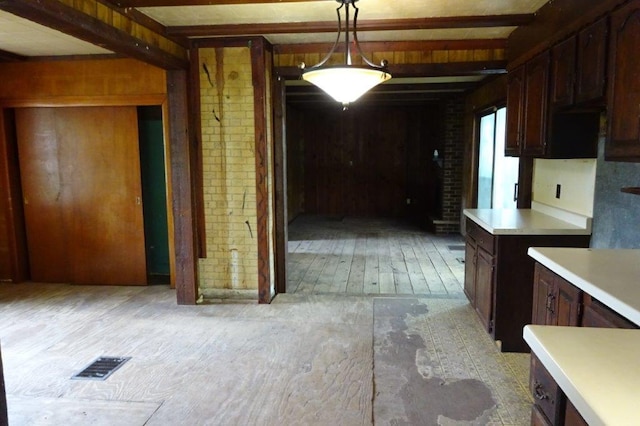 1305 La Crescent St, Campbell Twp, WI 54603 - kitchen featuring brick wall, light countertops, pendant lighting, and light wood-style floors