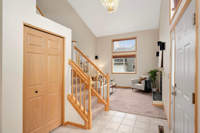 547 Woodduck Dr Unit G, Woodbury, MN 55125 - entrance foyer with lofted ceiling, stairs, light carpet, baseboards, and light tile patterned floors