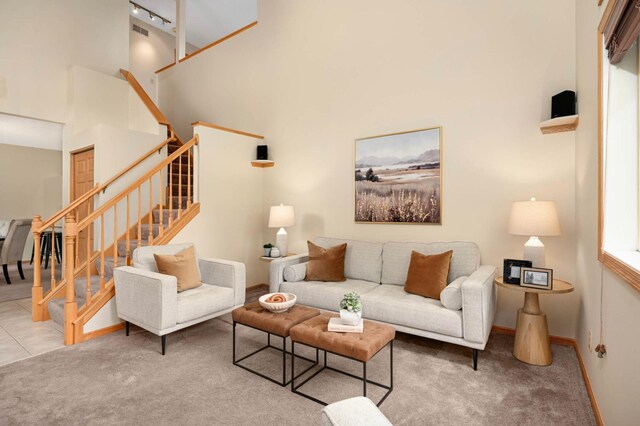 547 Woodduck Dr Unit G, Woodbury, MN 55125 - carpeted living area with a towering ceiling, stairs, and baseboards