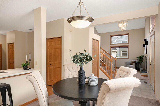 547 Woodduck Dr Unit G, Woodbury, MN 55125 - dining space featuring stairs and a chandelier