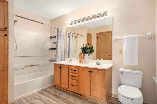 547 Woodduck Dr Unit G, Woodbury, MN 55125 - full bathroom featuring wood finished floors, shower / tub combo, double vanity, and toilet