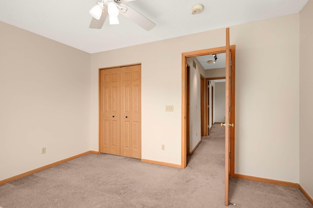 547 Woodduck Dr Unit G, Woodbury, MN 55125 - unfurnished bedroom with light carpet, baseboards, a closet, and a ceiling fan