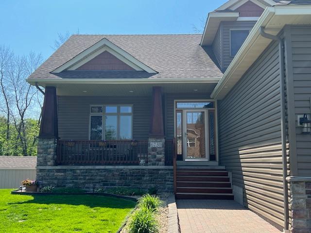 6730 210th Ct N, Forest Lake, MN 55025 - view of front facade with covered porch, roof with shingles, and a front lawn