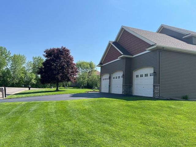 6730 210th Ct N, Forest Lake, MN 55025 - view of property exterior featuring asphalt driveway, a lawn, a garage, and a shingled roof