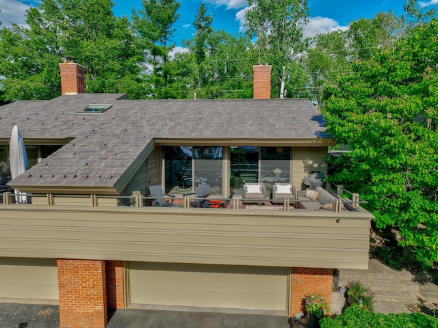 120 Eastbank Ct N, North Hudson, WI 54016 - back of property with a chimney, brick siding, and a balcony