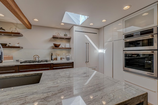 120 Eastbank Ct N, North Hudson, WI 54016 - kitchen featuring open shelves, a skylight, modern cabinets, appliances with stainless steel finishes, and beamed ceiling