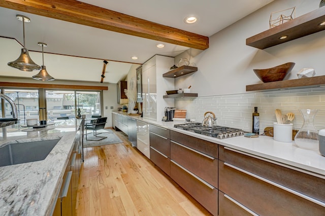 120 Eastbank Ct N, North Hudson, WI 54016 - kitchen featuring open shelves, a sink, stainless steel gas stovetop, light wood-style flooring, and backsplash