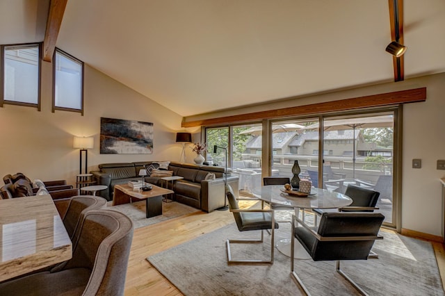 120 Eastbank Ct N, North Hudson, WI 54016 - dining space with wood finished floors, beam ceiling, healthy amount of natural light, and high vaulted ceiling
