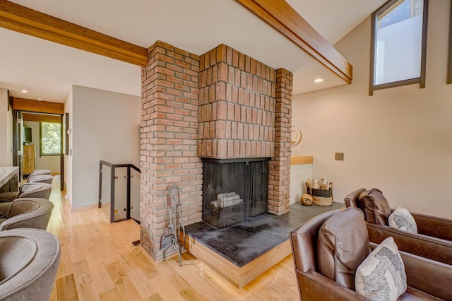 120 Eastbank Ct N, North Hudson, WI 54016 - living area featuring light wood-style floors, a brick fireplace, beam ceiling, and recessed lighting