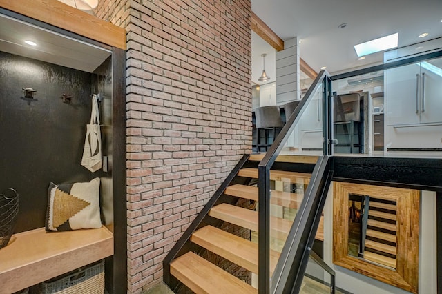 120 Eastbank Ct N, North Hudson, WI 54016 - staircase featuring a skylight and brick wall