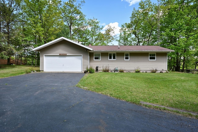 W2847 County Highway B, Madge Twp, WI 54870 - ranch-style house featuring an attached garage, asphalt driveway, a front lawn, and a chimney