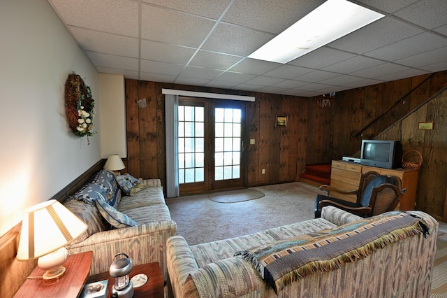 W2847 County Highway B, Madge Twp, WI 54870 - carpeted living room with wooden walls, a paneled ceiling, and stairway
