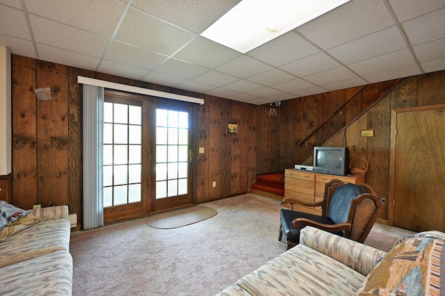 W2847 County Highway B, Madge Twp, WI 54870 - carpeted living area featuring wooden walls and a drop ceiling