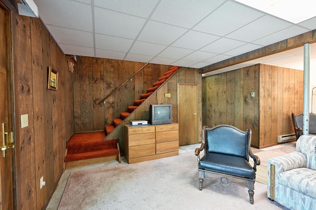 W2847 County Highway B, Madge Twp, WI 54870 - sitting room with wooden walls, carpet flooring, stairway, and a baseboard heating unit