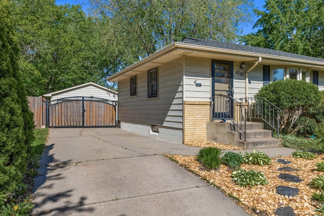 4342 Arthur St NE, Columbia Heights, MN 55421 - view of front facade with a gate, driveway, and a detached carport