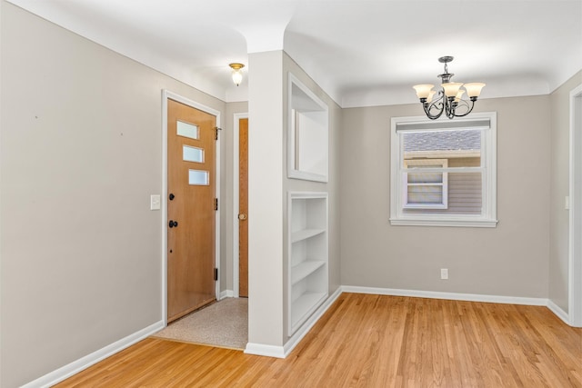 4342 Arthur St NE, Columbia Heights, MN 55421 - foyer entrance featuring a chandelier, baseboards, and light wood-type flooring