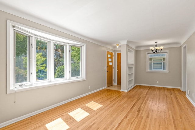 4342 Arthur St NE, Columbia Heights, MN 55421 - unfurnished room featuring a chandelier, light wood-style flooring, and baseboards