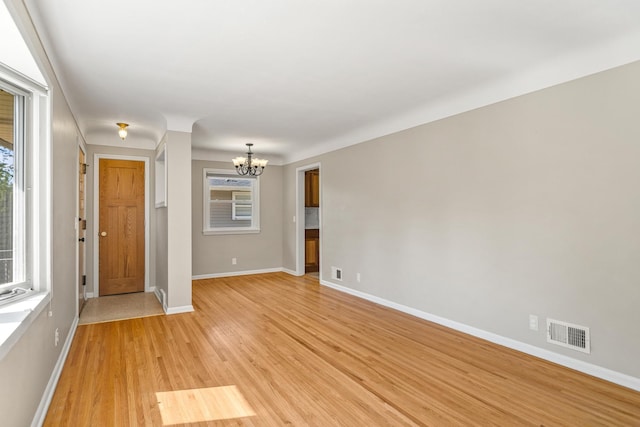 4342 Arthur St NE, Columbia Heights, MN 55421 - empty room featuring a chandelier, light wood finished floors, and baseboards