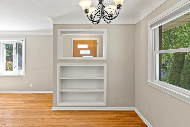 4342 Arthur St NE, Columbia Heights, MN 55421 - interior space with a chandelier, baseboards, and wood finished floors