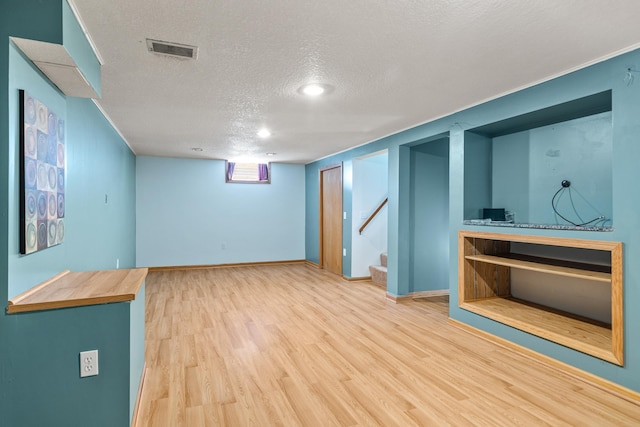 4342 Arthur St NE, Columbia Heights, MN 55421 - below grade area with a textured ceiling, wood finished floors, stairway, and baseboards