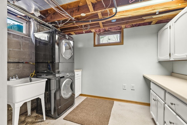 4342 Arthur St NE, Columbia Heights, MN 55421 - laundry room with stacked washing machine and dryer, cabinet space, and baseboards