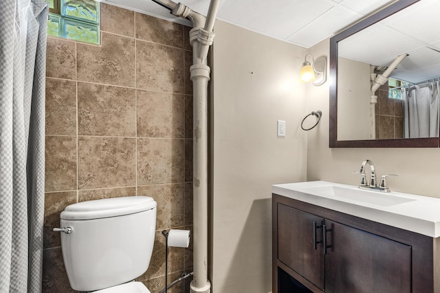 4342 Arthur St NE, Columbia Heights, MN 55421 - bathroom with vanity, toilet, a shower with shower curtain, and tile walls