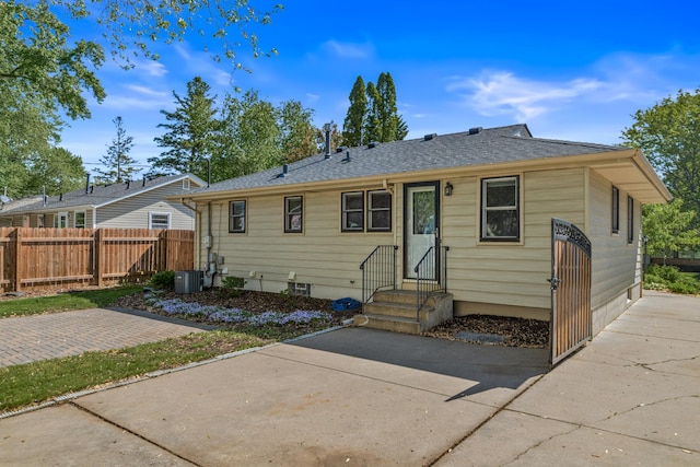 4342 Arthur St NE, Columbia Heights, MN 55421 - view of front facade with a patio area, cooling unit, and roof with shingles