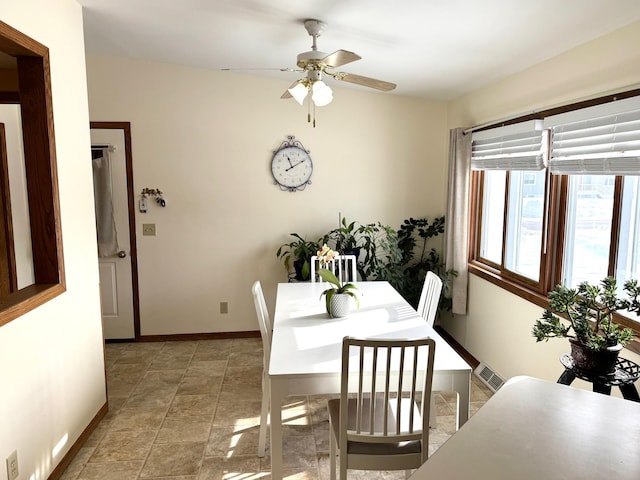 103 8th St SW, Roseau, MN 56751 - dining space with baseboards, ceiling fan, and light stone finish floors