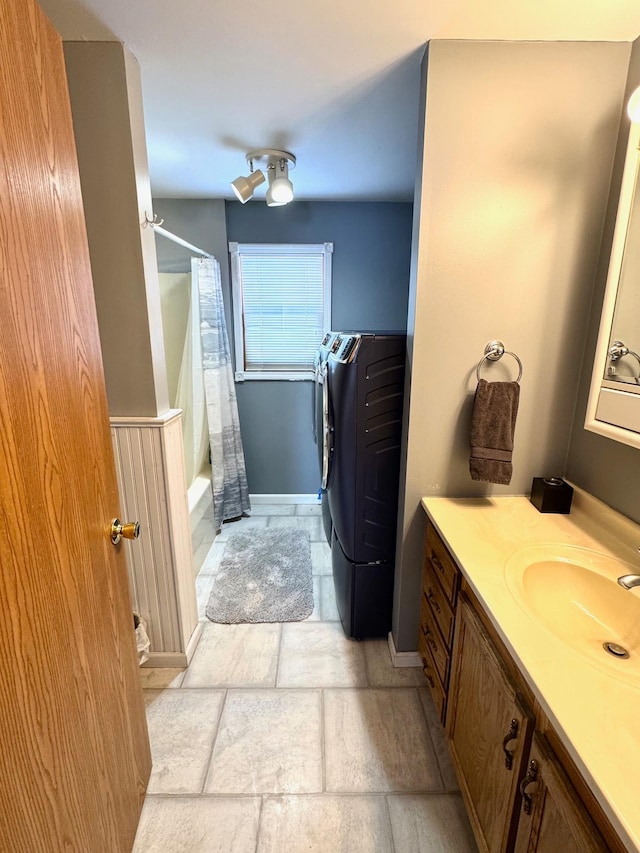 103 8th St SW, Roseau, MN 56751 - bathroom featuring vanity, baseboards, shower / bath combo with shower curtain, and stone finish floors