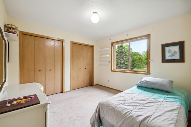 2031 Rose Creek Dr S, Fargo, ND 58104 - bedroom with two closets, light carpet, and baseboards