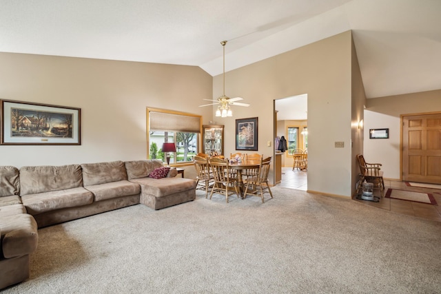 2031 Rose Creek Dr S, Fargo, ND 58104 - carpeted living room featuring high vaulted ceiling, tile patterned flooring, ceiling fan, and baseboards