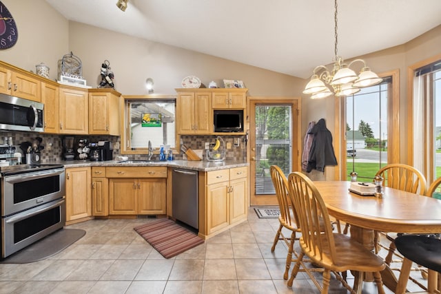 2031 Rose Creek Dr S, Fargo, ND 58104 - kitchen featuring stainless steel appliances, a sink, lofted ceiling, a chandelier, and backsplash