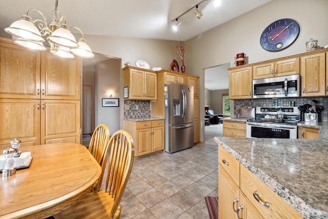 2031 Rose Creek Dr S, Fargo, ND 58104 - kitchen featuring stainless steel appliances, backsplash, vaulted ceiling, a chandelier, and decorative light fixtures