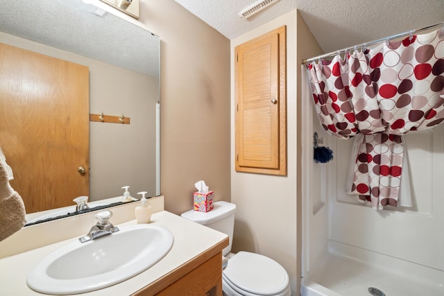 2031 Rose Creek Dr S, Fargo, ND 58104 - bathroom featuring a textured ceiling, vanity, a shower with shower curtain, and toilet
