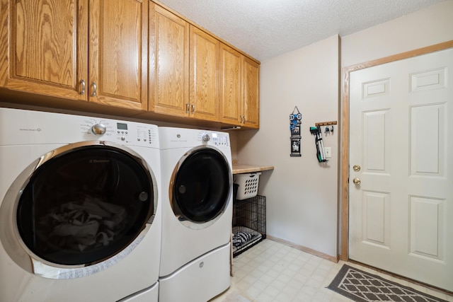 2031 Rose Creek Dr S, Fargo, ND 58104 - washroom with cabinet space, washing machine and dryer, light floors, a textured ceiling, and baseboards
