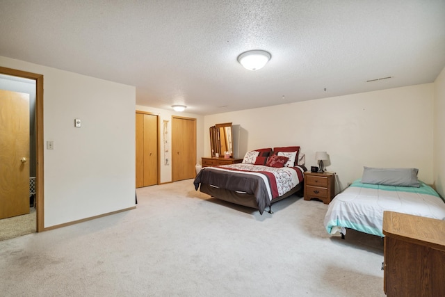 2031 Rose Creek Dr S, Fargo, ND 58104 - bedroom with carpet flooring, two closets, and a textured ceiling