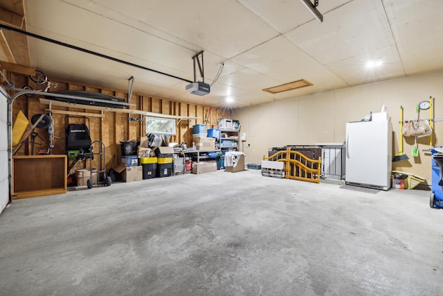 2031 Rose Creek Dr S, Fargo, ND 58104 - garage with freestanding refrigerator and a garage door opener