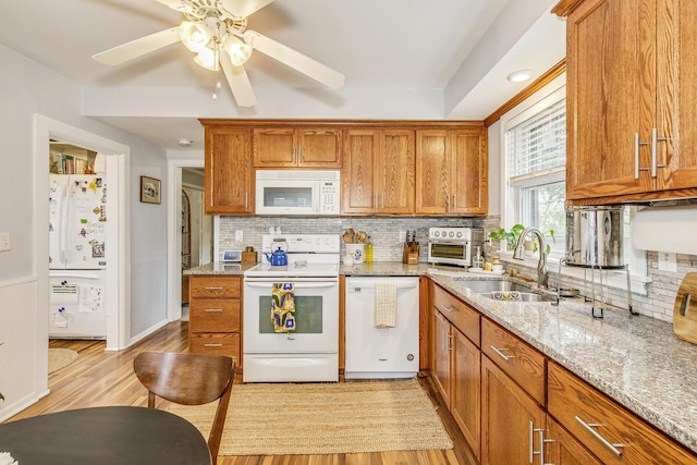 1491 Wynne Ave, Saint Paul, MN 55108 - kitchen with white appliances, a sink, light wood-type flooring, and decorative backsplash