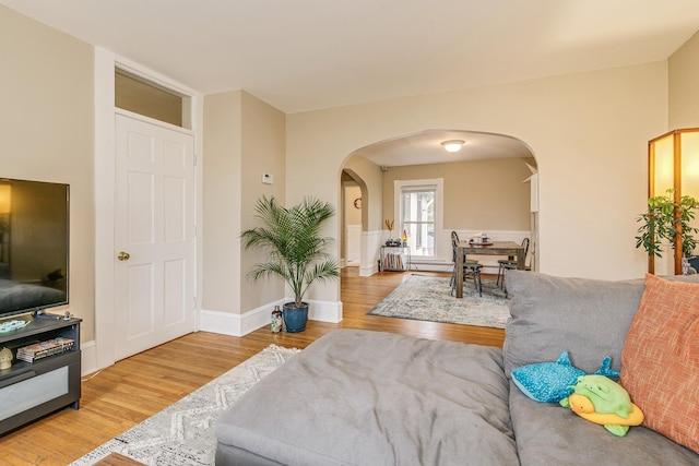 1491 Wynne Ave, Saint Paul, MN 55108 - living area with arched walkways, wood finished floors, and baseboards