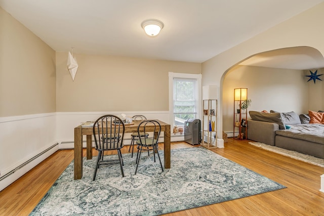 1491 Wynne Ave, Saint Paul, MN 55108 - dining area with arched walkways, baseboard heating, and wood finished floors