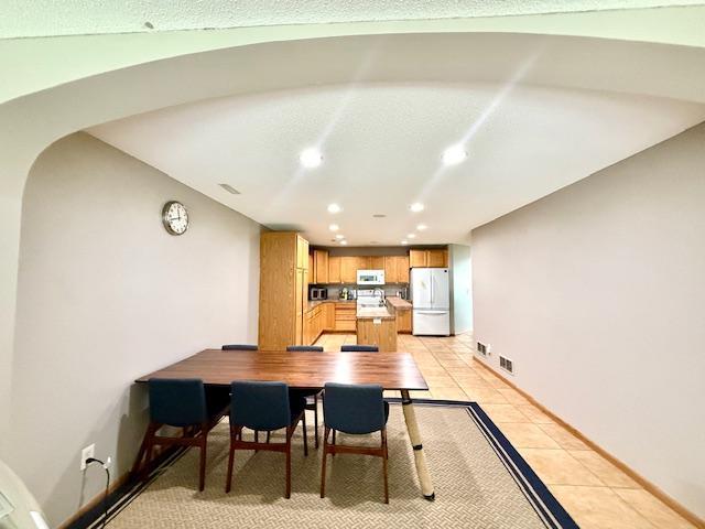 10809 Tyler Ct NE, Blaine, MN 55434 - dining area featuring recessed lighting, light tile patterned floors, and baseboards