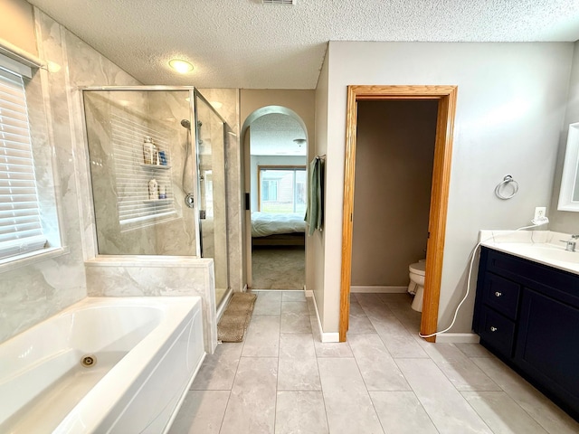 10809 Tyler Ct NE, Blaine, MN 55434 - full bathroom featuring a bath, a shower stall, a textured ceiling, vanity, and toilet