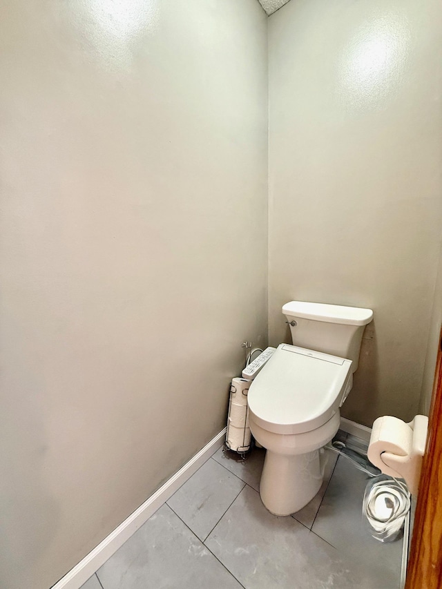 10809 Tyler Ct NE, Blaine, MN 55434 - bathroom featuring toilet, baseboards, and marble finish flooring